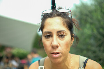 Dark-haired woman with perplexed and worried expression. The woman is thirty-eight years old and of...