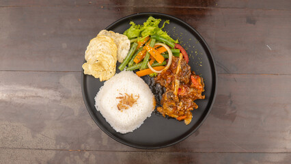 Overhead shot of a plate with rice, vegetables, and meat.