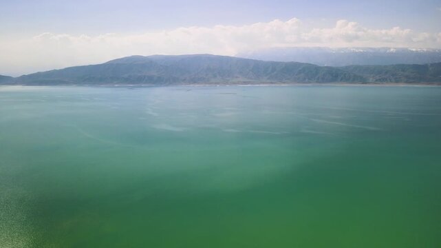 Toktogul Reservoir (284.3 km&sup2;),the largest in Central Asia.Turquoise water,sandy beaches and snow-capped Tien Shan on the horizon.Fed by the Naryn River and a major hydroelectric source (Toktogul HPP)