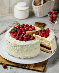 Enjoy the delightful White Cake with Raspberries and Coconut Topping
