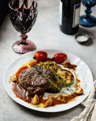 An Elegant Plate of Delicious Beef with Colorful Garnishes Accompanied
