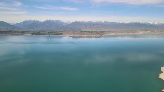 Toktogul Reservoir (284.3 km&sup2;),the largest in Central Asia.Turquoise water,sandy beaches and snow-capped Tien Shan on the horizon.Fed by the Naryn River and a major hydroelectric source (Toktogul HPP)