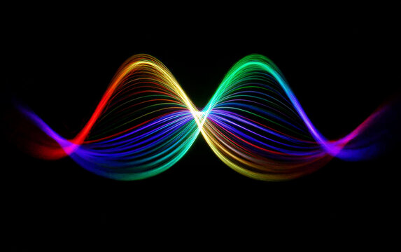 Colorful wave patterns with multiple light trails showing scientific waves