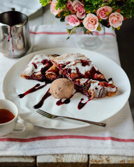 Enjoy a warm pastry with creamy ice cream and fruit