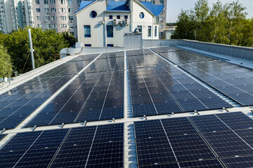 Rooftop solar panels on modern building with residential apartment blocks in the city © Sid Smith