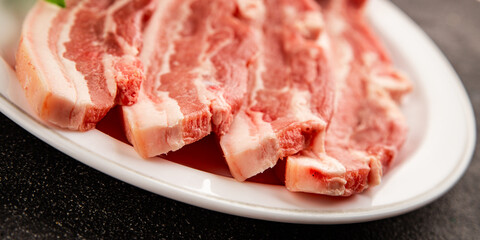 Bacon slice lard with meat slices pieces pork tenderloin portion size natural product tasty snack fresh delicious gourmet food background on the table rustic top view copy space