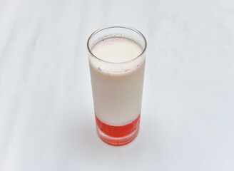 A Glass of Strawberry Milk on a White Background side view of healthy drink