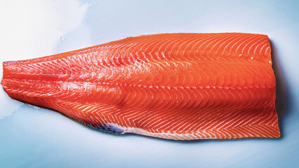 Fresh raw salmon fillet on a black background, healthy seafood rich in omega-3.