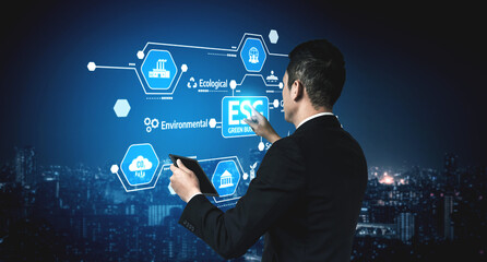 A businessman engages with a digital interface showcasing environmental technology concepts, emphasizing innovation and sustainability over a night city skyline. Tessel