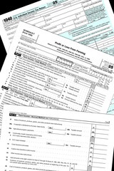 2025 tax year 1040 and schedule F, profit or loss from farming, forms lay on a black desktop.