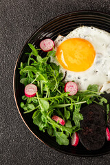 Eggs breakfast black pudding, egg, vegetables, arugula portion size natural product tasty snack fresh delicious gourmet food background on the table rustic top view copy space