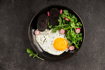 Eggs breakfast black pudding, egg, vegetables, arugula portion size natural product tasty snack fresh delicious gourmet food background on the table rustic top view copy space