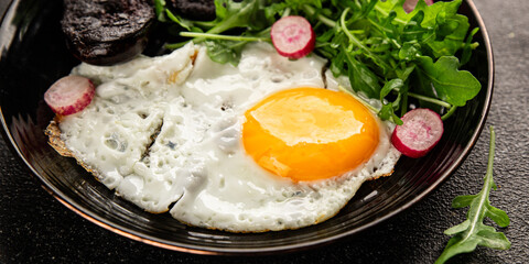 Eggs breakfast black pudding, egg, vegetables, arugula portion size natural product tasty snack fresh delicious gourmet food background on the table rustic top view copy space