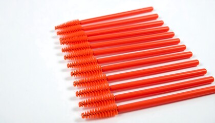 Rows of bright orange eyelash applicators