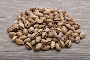 Roasted salted pistachios in shells, traditional snack food.	