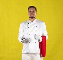 bearded waiter in a white suit on a yellow background