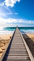 Wooden pier extending into a turquoise ocean under a bright sky
