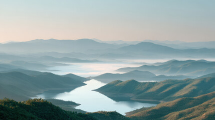 breathtaking aerial view of mountains shrouded in morning fog with tranquil lake nestled among them
