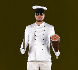 Naklejka premium Portrait of a male chef with kitchen knives on a yellow background