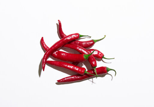Many red chilli pepers isolated on a white
