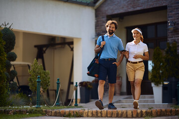 Fototapeta premium Happy couple of golfers while enjoying day at golf club.
