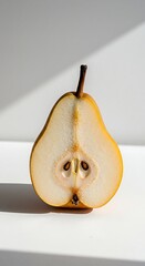 A halved pear with its seeds visible, isolated on white background