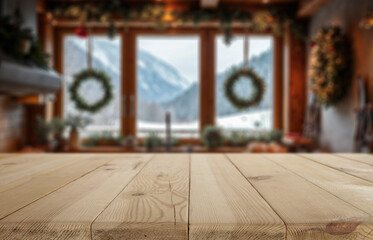 Empty wooden table with copy space for product placement in cozy alpine kitchen interior and window overlooking snowy trees and winter landscape. Seasonal advertising, home comfort, winter holidays.