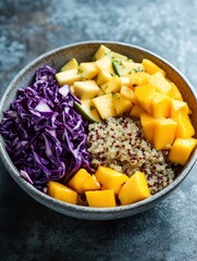 Colorful quinoa bowl with fresh mango, apples, red cabbage, and lime served in a rustic bowl on a textured surface