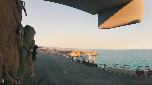 Marines Boarding Military Aircraft on Navy Ship
