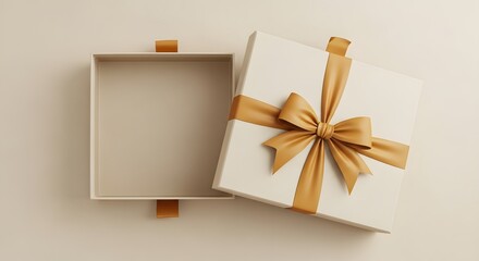 Elegant open gift box with golden ribbon on a neutral background