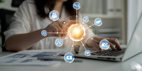 A business person engages with digital network icons, showcasing the power of technology and innovation in a modern office setting, emphasizing communication and connectivity. Crux