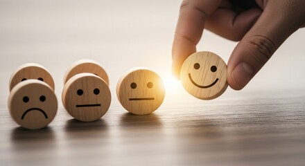 Hand selects happy face emoji from neutral and sad faces showing positive customer feedback choice