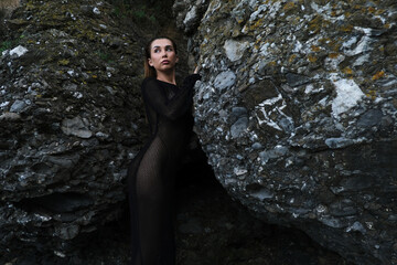 woman in bikini on tropical beach near the mountain