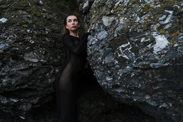 woman in bikini on tropical beach near the mountain