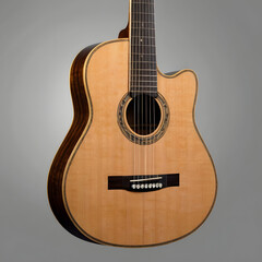 Obraz premium An acoustic guitar, artfully crafted from light-colored wood. This studio shot shows the elegance of a classic instrument.