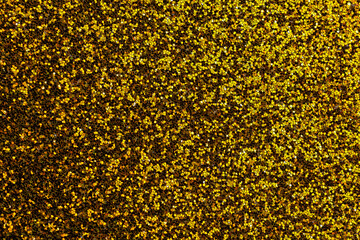 A gold and black background with a lot of gold glitter