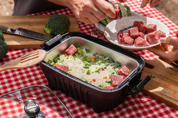 Chopping Fresh Broccoli for Outdoor Cooking on a Picnic