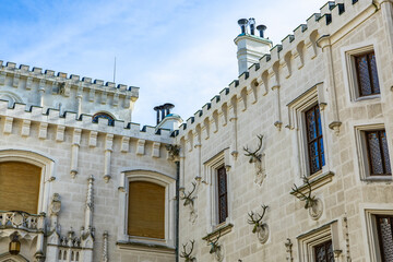Historic european castle exterior with ornate architecture and decorative antlers