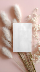 Blank card with pampas grass and dried flowers on pastel pink background, perfect for wedding invitations, greeting cards, or elegant boho stationery mockups.
