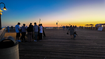 Pismo Beach Looking at people walking the pier at sunset with silhouettes as people enjoy the sunset