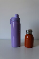 Composition with colorful reusable and stainless thermal bottles for sports, travel