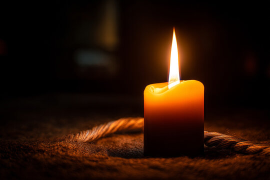 A peaceful image of a flame from a single candle flickering softly in a darkened room, promoting a meditative mood.