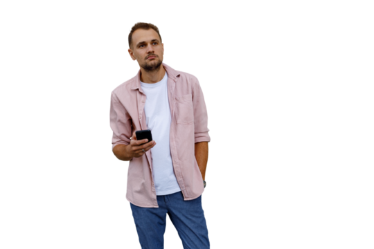 Young man holding smartphone, looking up, thinking and contemplating new ideas, transparent background