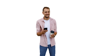 Young man smiling, holding smartphone and coffee cup, enjoying casual social media, transparent background