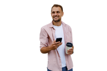Happy man holding smartphone and coffee, looking away, enjoying social media and break time