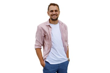 Happy young man smiling, standing with hands in pockets, looking at camera with positive expression on transparent background
