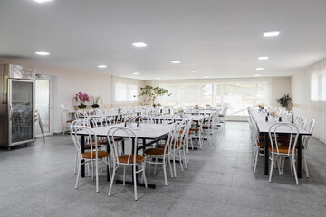 The Modern Dining Hall features White Furnishings along with an abundance of Natural Light