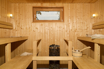 Beautiful Wooden Interior of a Sauna Featuring Cozy Benches and a Relaxing Window View