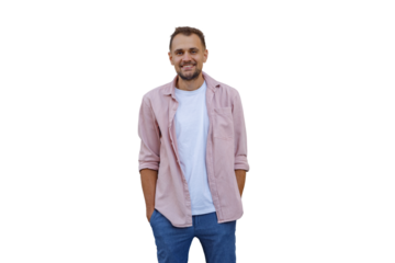 Smiling man in pink shirt and jeans, standing with hands in pockets, posing for portrait, transparent background