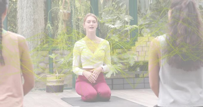 Yoga instructor greeting students, showing breathing, placing hands chest belly, promoting wellness